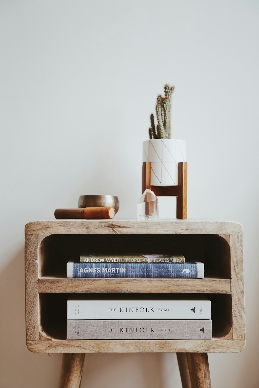 Styled console with books and ceramics